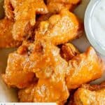 Copycat Hooters wings in on parchment paper.