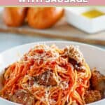 A bowl of Instant Pot spaghetti with pieces of Italian sausage.