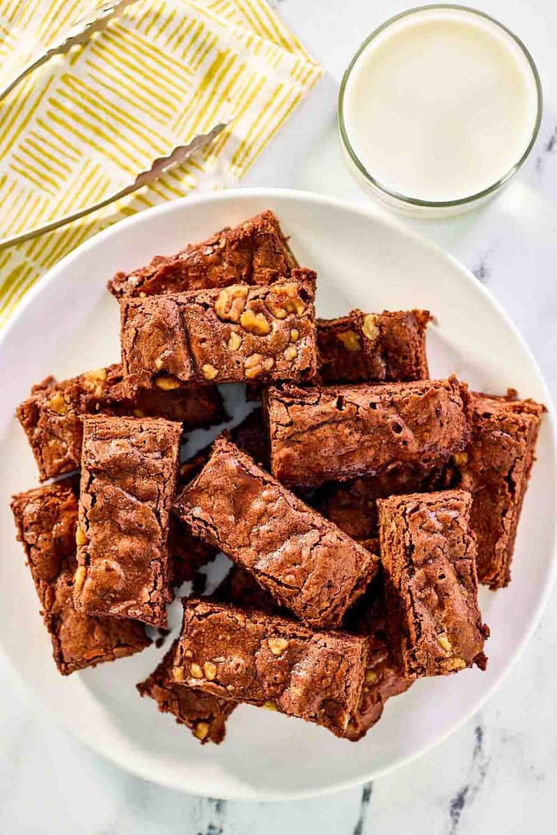 Kahlua brownies on a plate and a glass of milk.