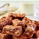 Kahlua brownies with nuts and a glass of milk behind them.