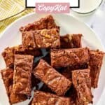 Kahlua brownies on a large plate and a glass of milk.