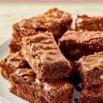 Kahlua brownies stacked on a large plate.