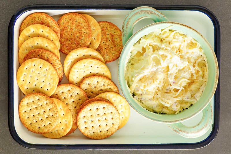 Copycat Kroger Jarlsberg cheese dip and crackers on a small serving tray.