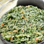 Homemade Lawry's creamed spinach with onion and bacon in a dish.