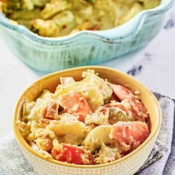 A bowl of copycat Luby's squash casserole and the casserole behind it.