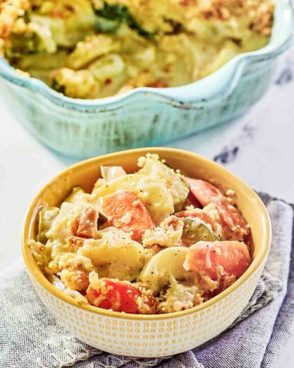 A bowl of copycat Luby's squash casserole and the casserole behind it.