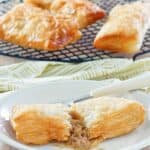 Copycat McDonald's apple pie on a plate and three on a wire rack.