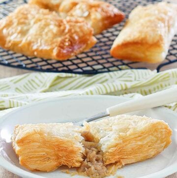 Copycat McDonald's apple pie on a plate and three on a wire rack.