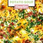 Homemade O'Charley's loaded potato soup topped with cheese, bacon, and chives.