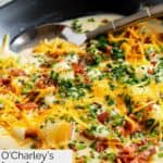 A bowl of homemade O'Charley's loaded potato soup with garnishes.