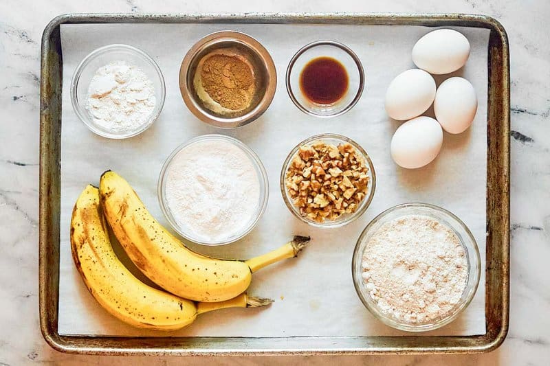 Copycat Otis Spunkmeyer banana nut muffins ingredients on a tray.