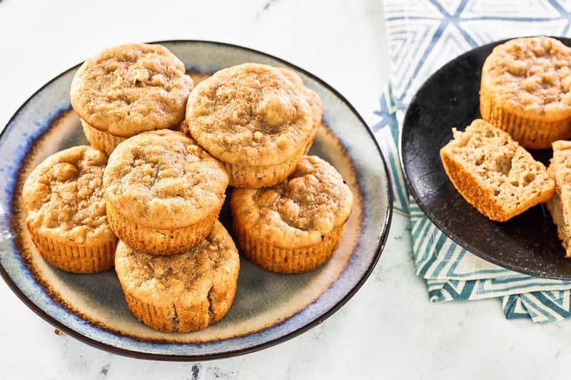 Copycat Otis Spunkmeyer banana nut muffins stacked on plates.