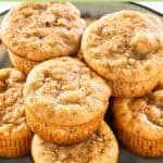 Homemade Otis Spunkmeyer banana nut muffins piled on a plate.