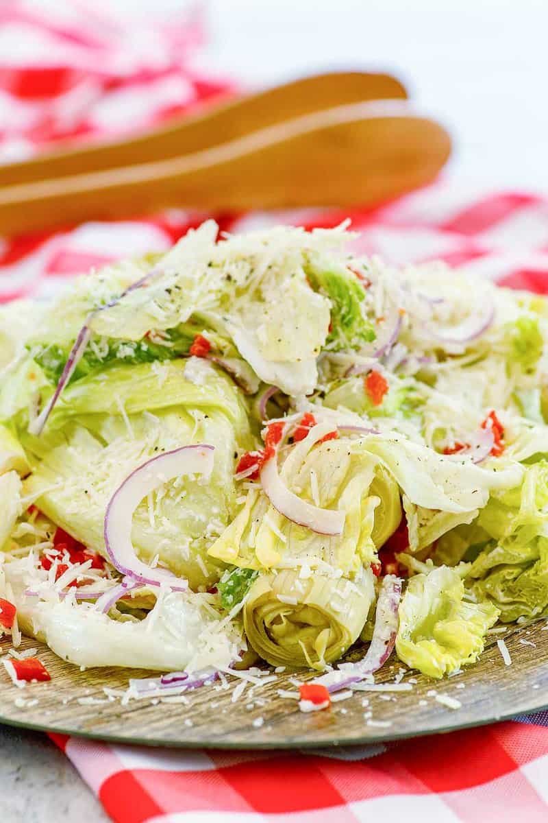 Copycat Pasta House Company salad with dressing on a plate.