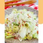 Homemade Pasta House salad and dressing on a plate.