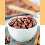 A bowl of spiced pecans and cinnamon sticks.