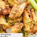Several homemade Wingstop garlic parmesan chicken wings on a plate.