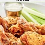 Homemade Wingstop lemon pepper chicken wings, celery, and a cup of dipping sauce.