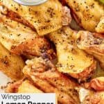 Homemade Wingstop lemon pepper chicken wings and a cup of dipping sauce.