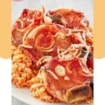 A platter of baked pork chops and rice.