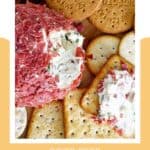 Dried beef cheese ball and assorted crackers next to it.