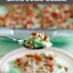 Homemade Furr's Cafeteria lime jello salad on a spoon held over the dish.