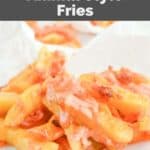 Homemade animal style fries on parchment paper.