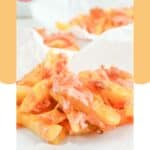 Homemade animal style fries on parchment paper.