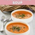 Homemade La Madeleine tomato basil soup garnished with fresh basil.