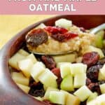 Homemade McDonald's fruit and maple oatmeal on a spoon over a bowl of it.