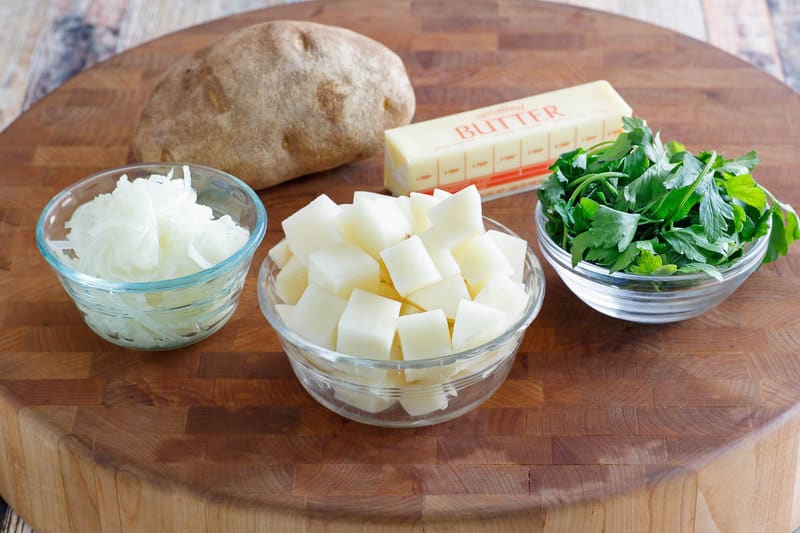 Parsley potatoes ingredients on a wood board.