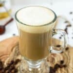 Homemade Starbucks vanilla latte drink and coffee beans.
