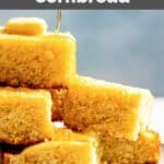 Homemade Tippin's cornbread slices and honey being drizzled over them.