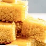 Pieces of homemade Tippin's cornbread topped with butter and honey.