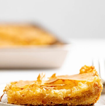 Copycat Treebeards butter cake slice on a plate with the cake behind it.