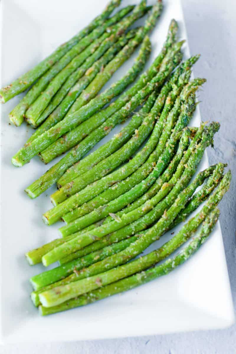 Air fryer asparagus spears on a platter.