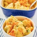 Baked cauliflower with cheese sauce serving in a bowl in front of the dish.