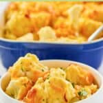 Baked cauliflower with cheese sauce in a bowl and the dish behind it.