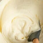 Homemade Cinnabon frosting and a spatula in a bowl.