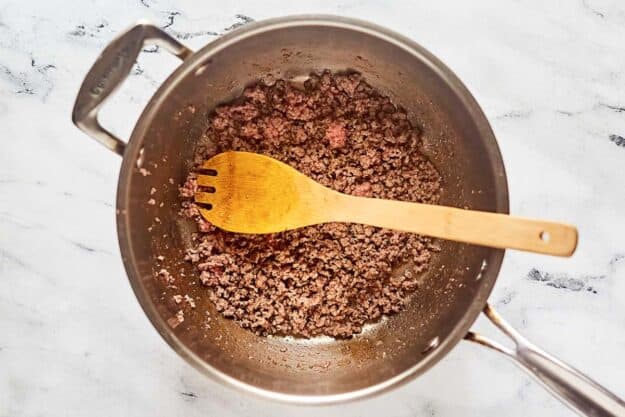 Browned ground beef for cowboy soup in a pan.