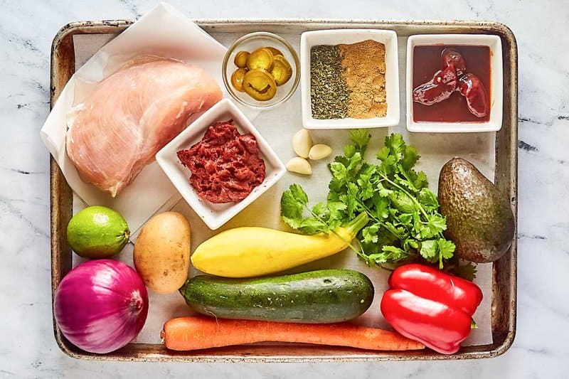 Copycat El Tortio's chicken tortilla soup ingredients on a tray.