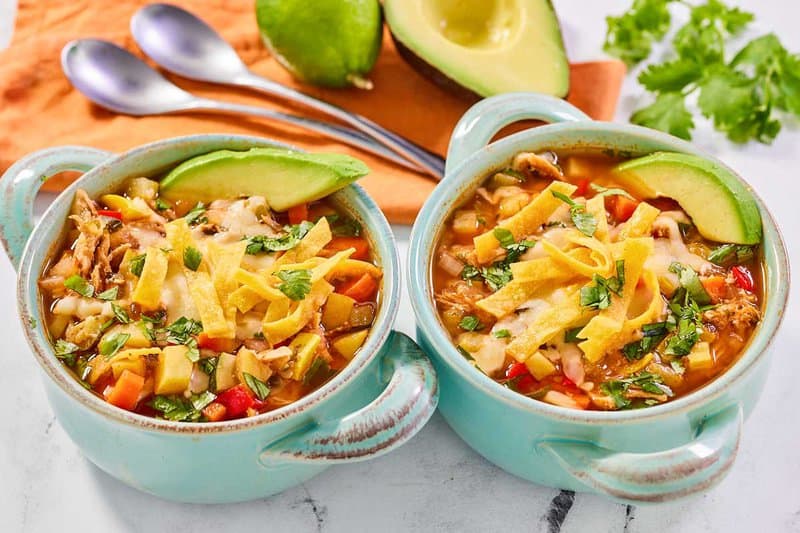 Two bowls of copycat El Tortio's chicken tortilla soup.