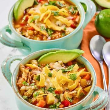 Copycat El Torito's chicken tortilla soup in two bowls.