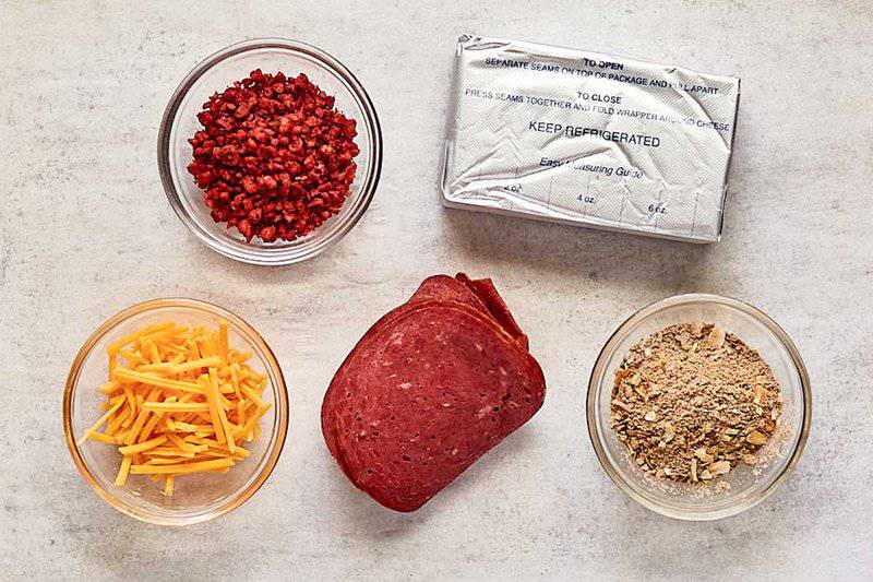 French onion cheese ball ingredients on parchment paper.