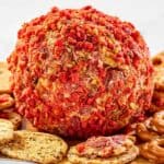 French onion cheese ball and crackers on a platter.