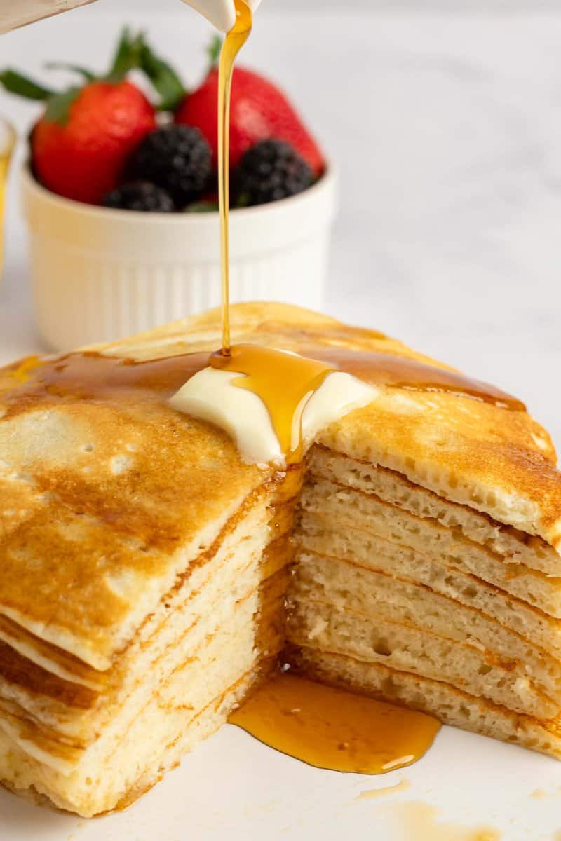 Copycat IHOP buttermilk pancakes with butter and syrup on a plate.