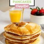 Homemade IHOP buttermilk pancakes with syrup being poured over them.