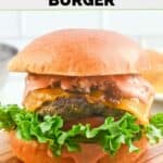 Homemade In and Out animal stye burger on a small wood serving board.