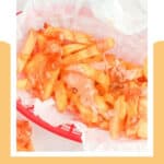 Copycat In N Out Animal style fries on parchment paper in a serving basket.
