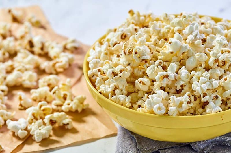 Instant pot popcorn in a bowl and scattered beside it.